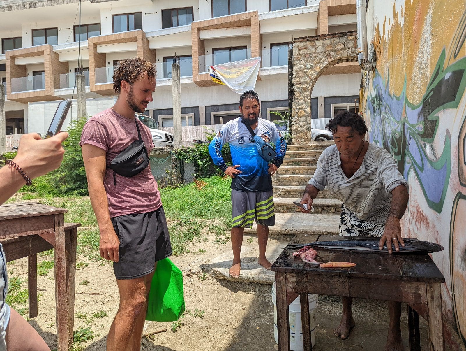 Local fisherman filleting fresh catch on the beach