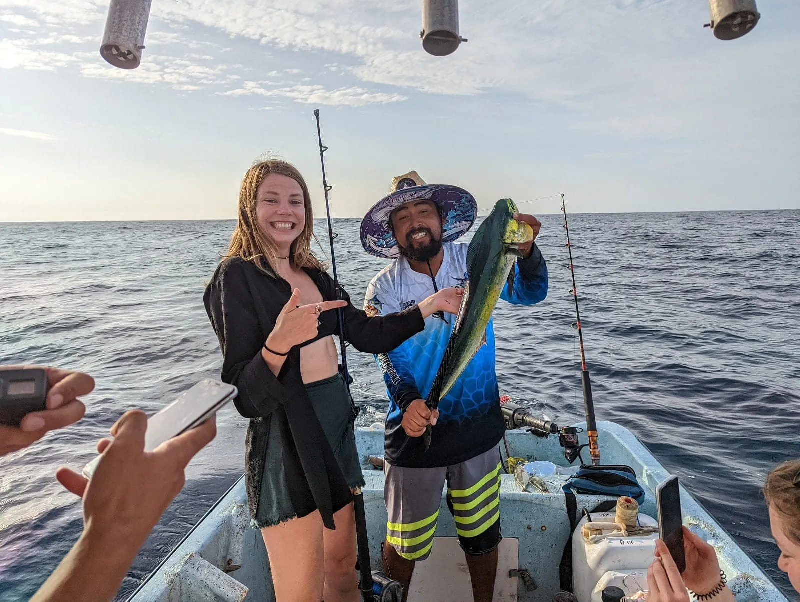 Happy tourist holding fresh caught Mahi Mahi fish