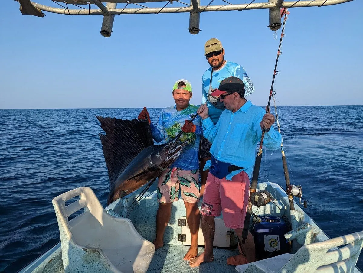 Proud fishermen displaying large sailfish catch