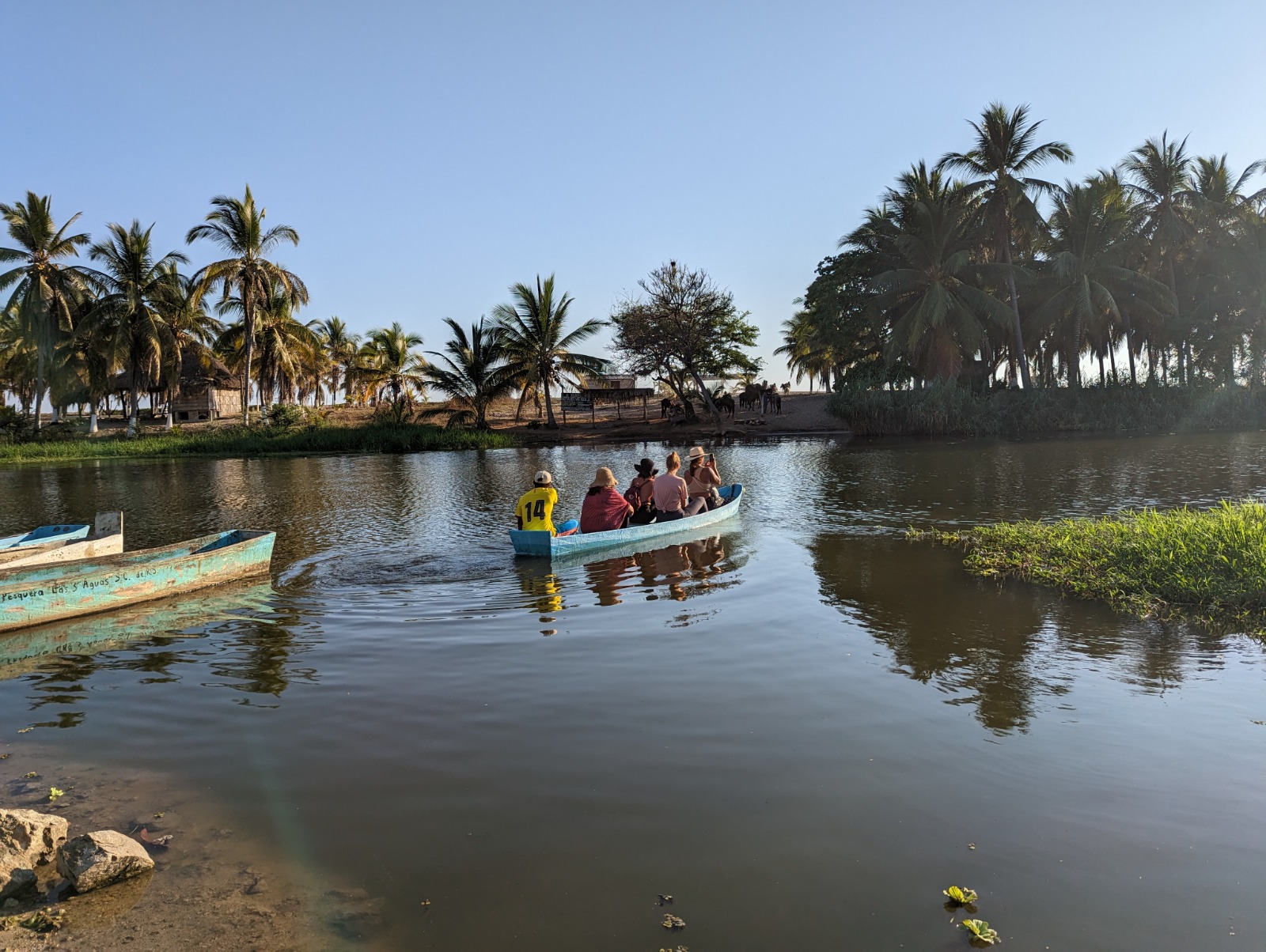 Group crossing Manialtepec Lagoon by boat